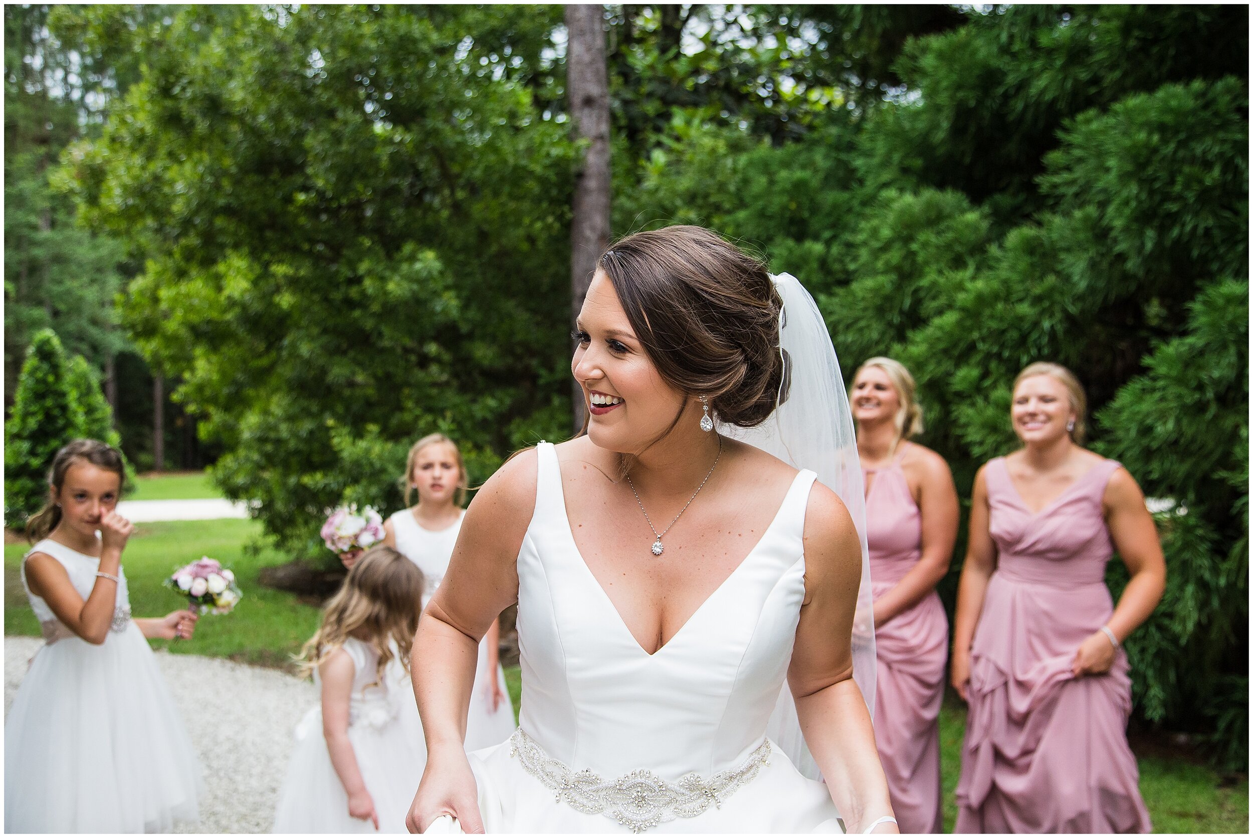 bride smiling in front of bridesmaids at bella sera gardens