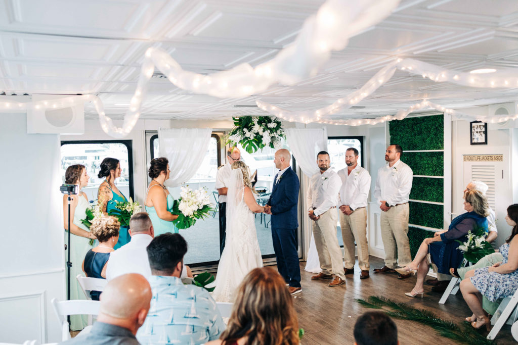 bride and groom say their vows aboard the solaris yacht by sunquest cruises