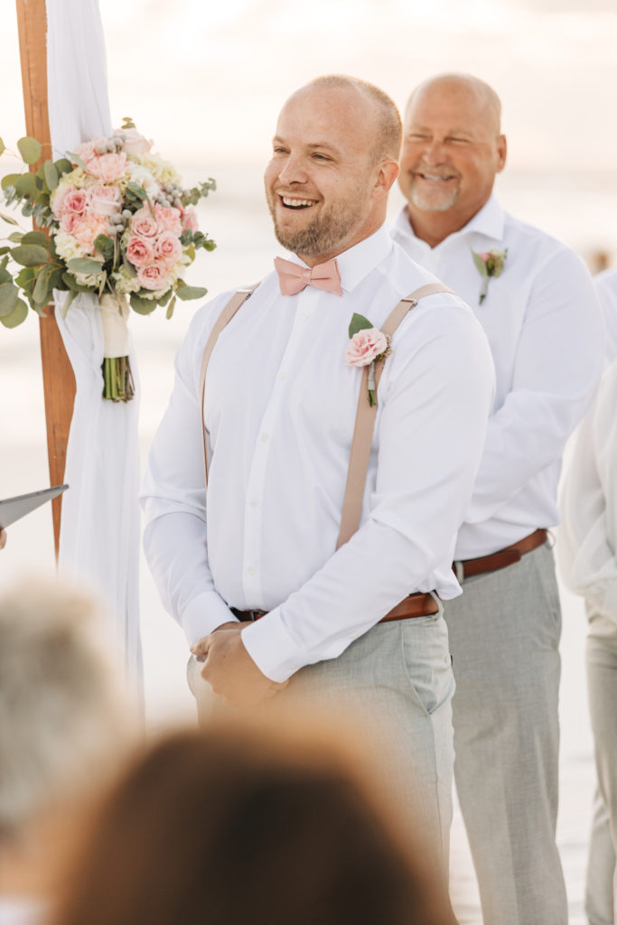 groom smiles during wedding ceremony on Miramar Beach Florida