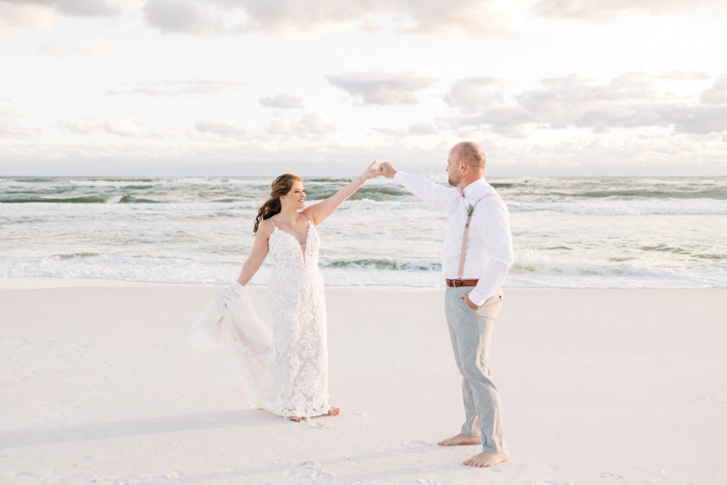 Groom spins bride for wedding photo on Miramar Beach in Florida with SunQuest Cruises