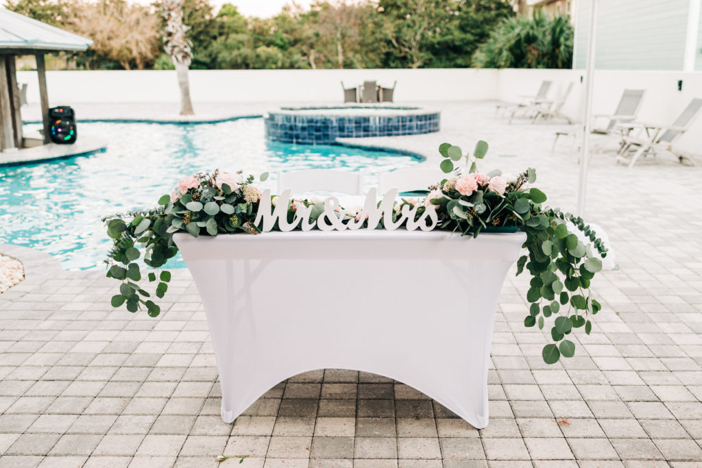 bride and groom head table at reception poolside at a house in Destin Florida