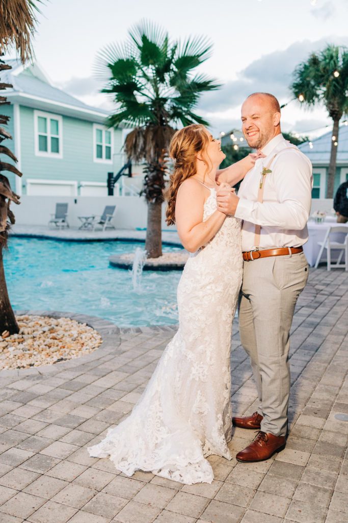 bride and groom dance poolside at their wedding reception in miramar beach florida