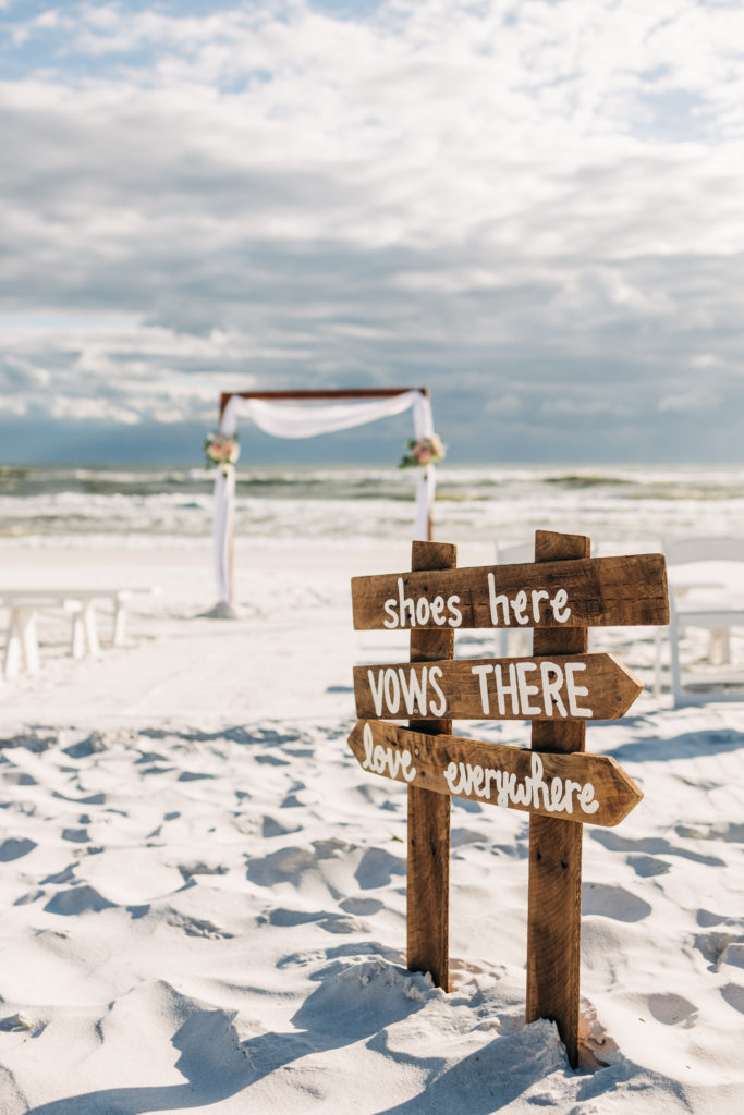 sign for beach ceremony in Miramar Beach Florida to take your shoes off